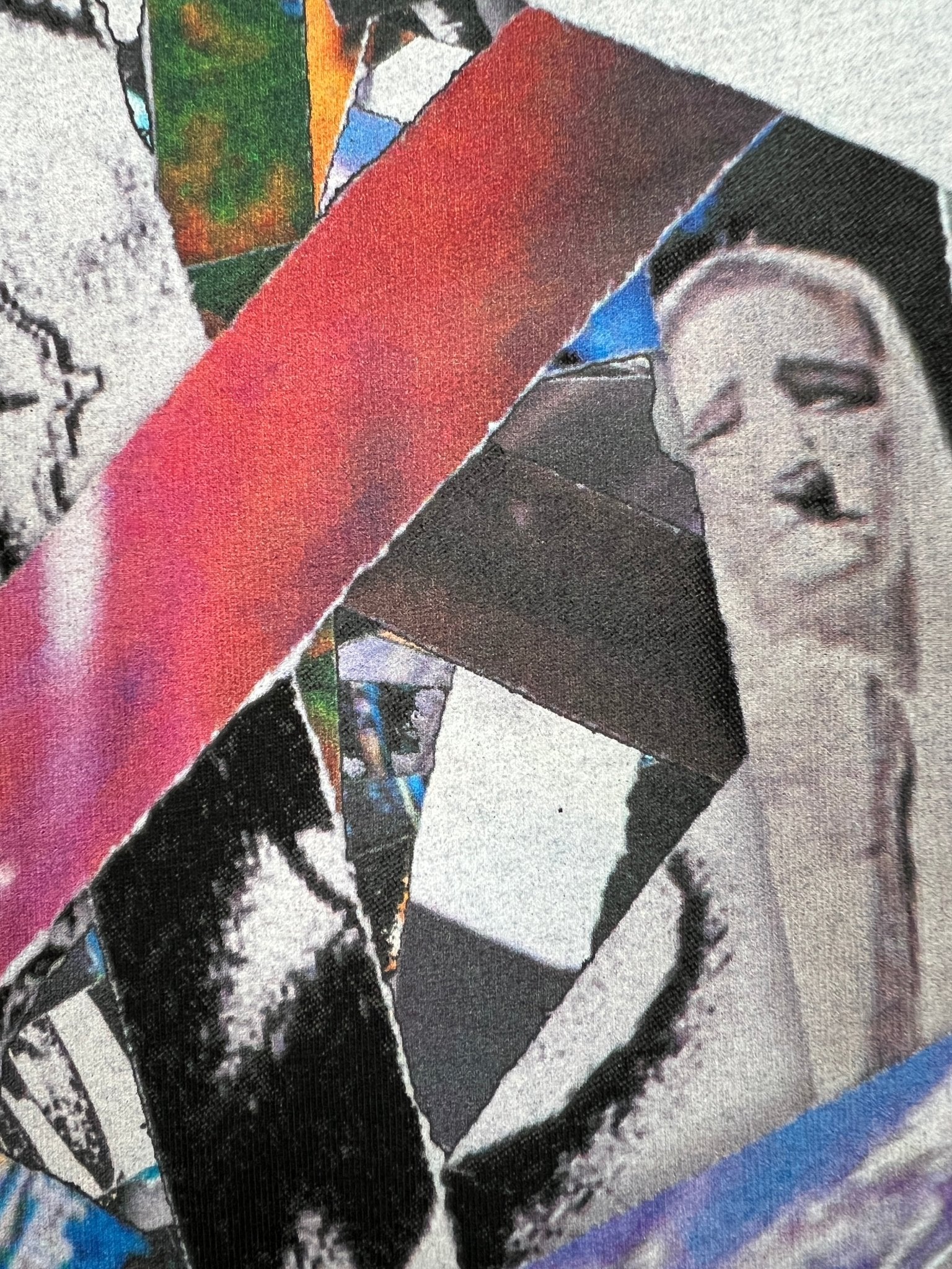 The Purple Brand P109-CBSC Clean Jersey SS Tee Blk by PURPLE BRAND is a collage graphic T-shirt with torn images and layered colors like red, blue, and grayscale on black. A face-like figure emerges from overlapping fragments. Made from 100% cotton for comfort and style.