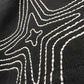 Close-up of the PURPLE BRAND P117-HBJS325 HWT Jersey SS Tee in Black, featuring distinctive white stitched lines forming a bold geometric star pattern on the graphic t-shirt.
