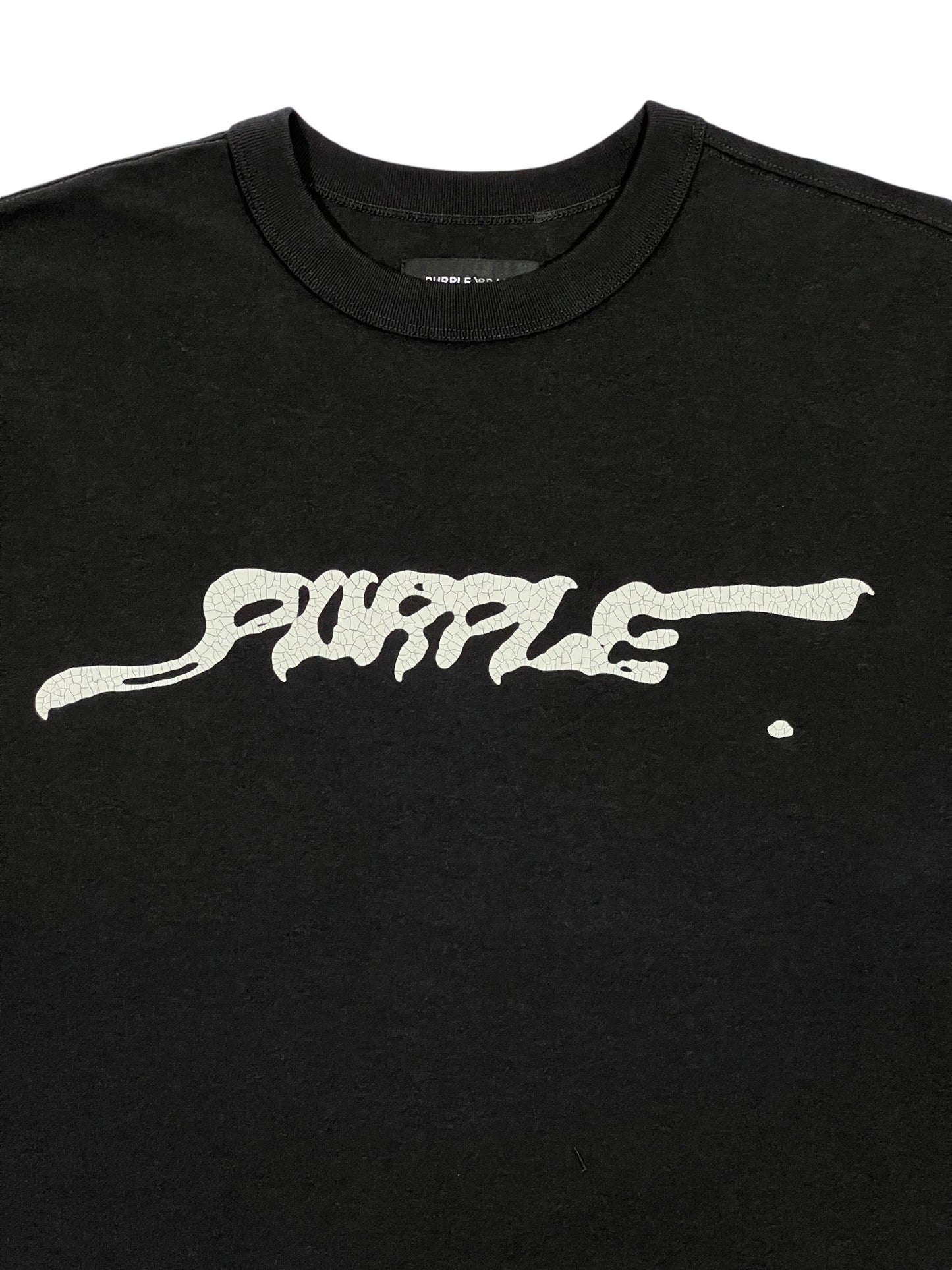 A black textured jersey long-sleeve tee from PURPLE BRAND, featuring the word "PURPLE" in wavy white lettering on the front.