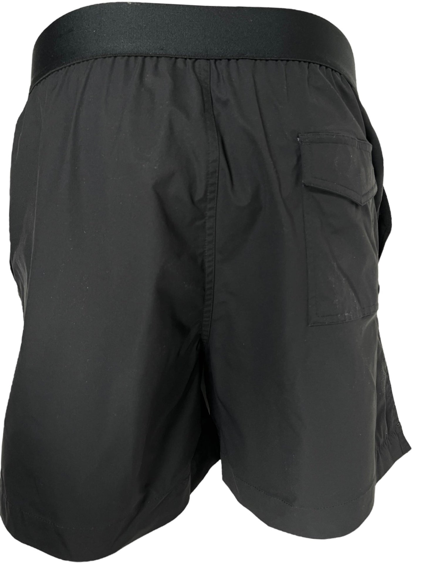 Black athletic shorts with an elastic waistband and a single pocket on the side, made from quick-drying swim fabric. The PURPLE BRAND P548-PFBB SWIM SHORTS BLACK, part of the Pre Fall 2024 White Label collection, are displayed from the back.