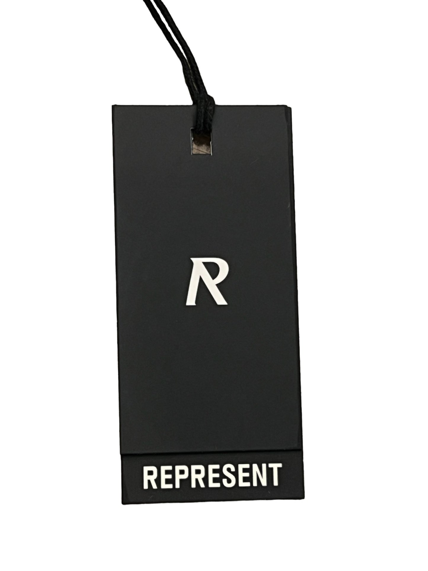 Black rectangular clothing tag with a white "R" in the center and the word "REPRESENT" at the bottom, attached to an oversized fit luxury cotton t-shirt from the REPRESENT MLM410-72 SPIRITS OF SUMMER T-SHIRT WHI collection by REPRESENT.