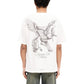 A person in a Represent MLM41066 Elegance in Motion Tee by REPRESENT, made of soft jersey cotton with an eagle and horse print on the back, paired effortlessly with loose jeans.