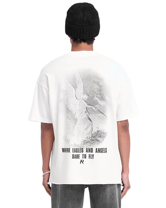 A person is dressed in the Represent MLM4222 Godspeed T-shirt Flat White by REPRESENT, which showcases an oversized fit and features a cracked graphic of an angel with the phrase "Where Eagles and Angels Dare to Fly" on the back.