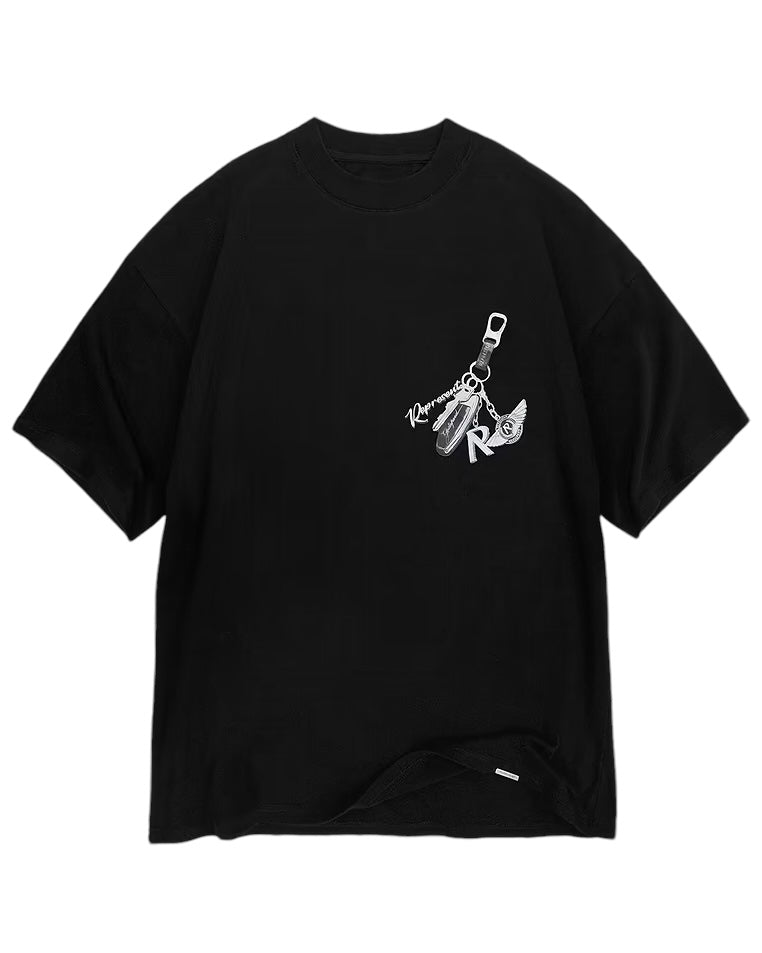 Represent MLM4236 Keys To The Club T-Shirt in Jet Black by REPRESENT, features an oversized fit with a keychain design on the front, showcasing keys, a USB stick, and the letter "R." The artistic pearl print graphic adds a touch of elegance to its casual style.