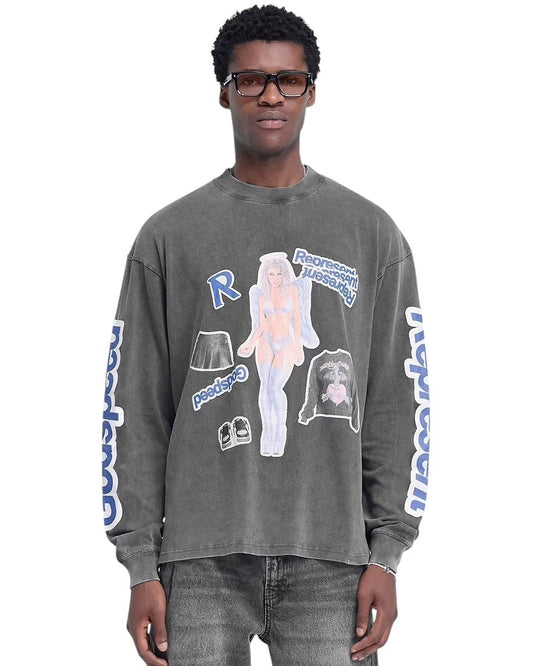 A man is wearing the Represent MLM4244 Question Your Innocence LS Grey, which features a vintage grey design with a cracked print graphic of a cartoon character and text on the front and sleeves. He complements its slightly oversized fit with glasses and jeans, effortlessly blending style and comfort.