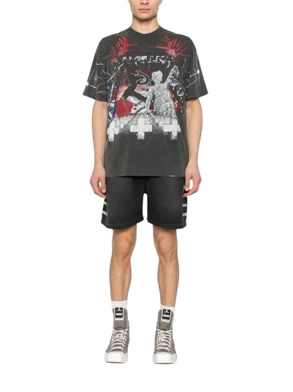 A man in the REPRESENT MLM4354 Master Of Puppets Tee VTG Grey with a crew neck, paired with black shorts and high-top sneakers, stands against a white background.