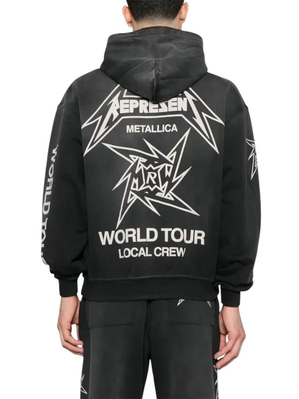 A person in a Represent MLM4370 40 Year Anniversary Zip Hood Blk by REPRESENT, showcasing "Metallica 40 Year Anniversary" with a star graphic and "World Tour Local Crew" on the back.