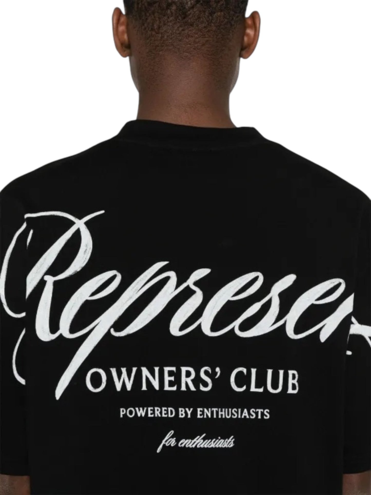 Back view of a person wearing the Represent OCM41201 Club Script T-shirt in black, showcasing "Represent Owners' Club" in crisp white letters, highlighting their unique style.