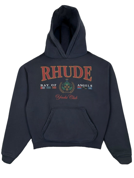 The Rhude Bay Of Angels Yacht Hood Black is a 100% cotton hoodie from RHUDE, featuring nautical graphics and "RHUDE Bay of Angels Yacht Club," making it an essential graphic hoodie.