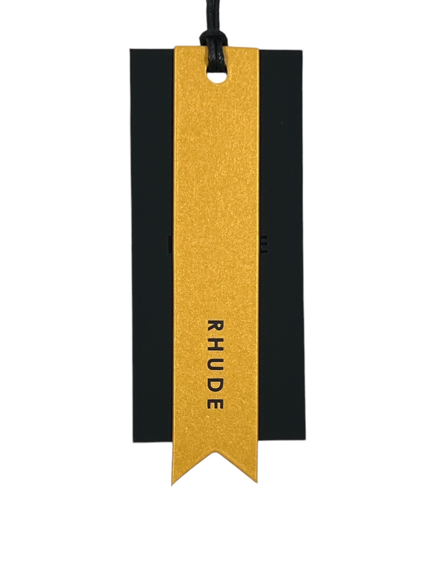 A black rectangular card with a gold ribbon tag elegantly displays the RHUDE logo in bold black letters, similar to their notable Rhude Bordeaux Wine Tee Vtg White collection.