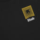 Rhude Chevron Logo Repeat Tee in vintage black by RHUDE features a custom-fit design with a yellow geometric pattern and the iconic white "Rhude" printed on the chest.