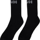 The RHUDE Classic Logo Socks in black/white are calf-high with a knit stretch, featuring a white jacquard logo that partially reads "UDE" on each sock.