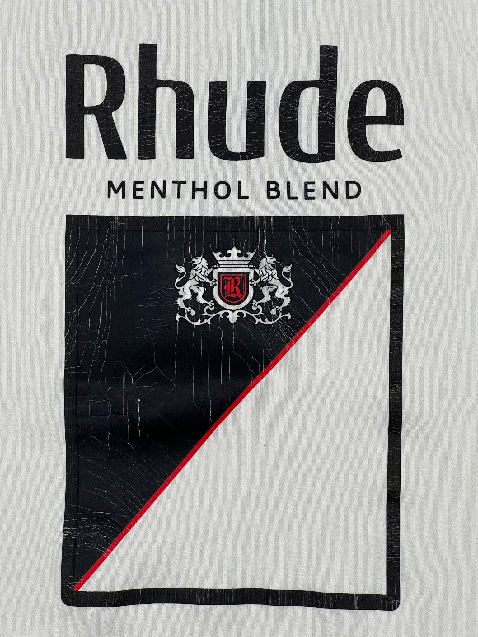 The RHUDE Collins Fumar Tee in Vintage White/Black/Red features "Rhude" above "Menthol Blend" with a black and white shield, a red diagonal line, and a crest. Made from 100% cotton for comfort and style.