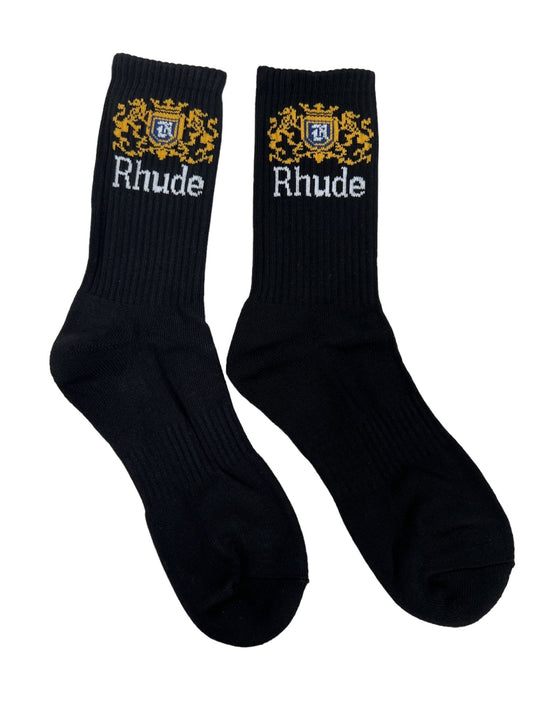 A pair of RHUDE CREST LOGO SOCK BLK WHITE YELLOW featuring the "Rhude" text and a striking gold and blue jacquard logo design near the top.