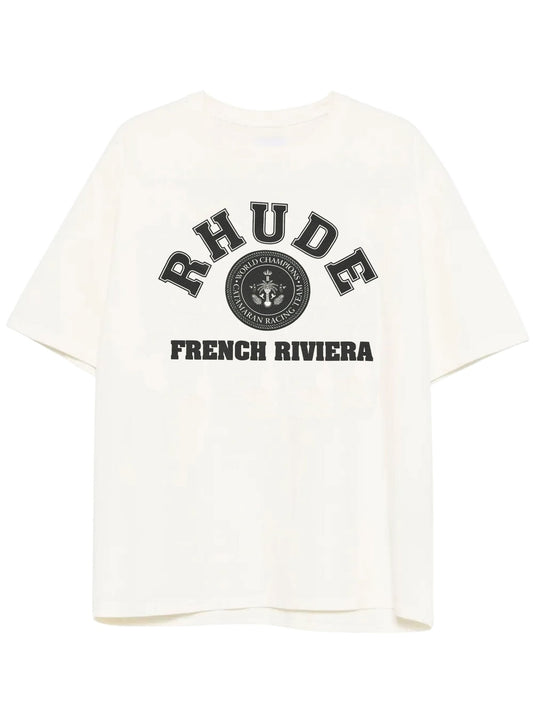 Crafted with premium quality, the Rhude French Riviera Tee White from RHUDE features "RHUDE FRENCH RIVIERA" and a black emblem on the front.