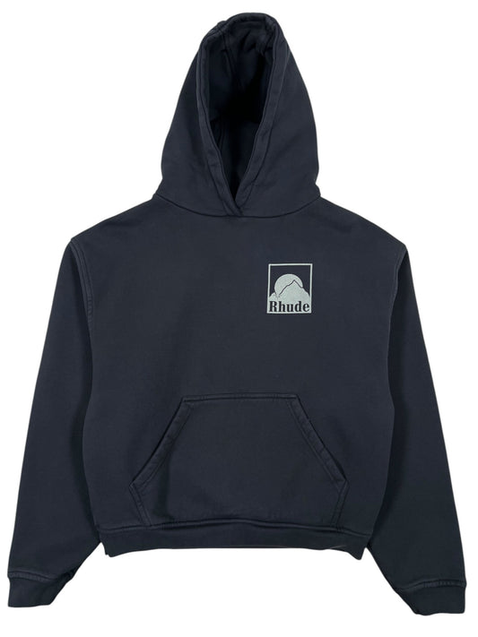 The RHUDE Moonlight Badge Hood Black offers comfort with a front pocket and rectangular "Rhude" logo on the upper left. This stylish graphic hoodie is a standout in any wardrobe.