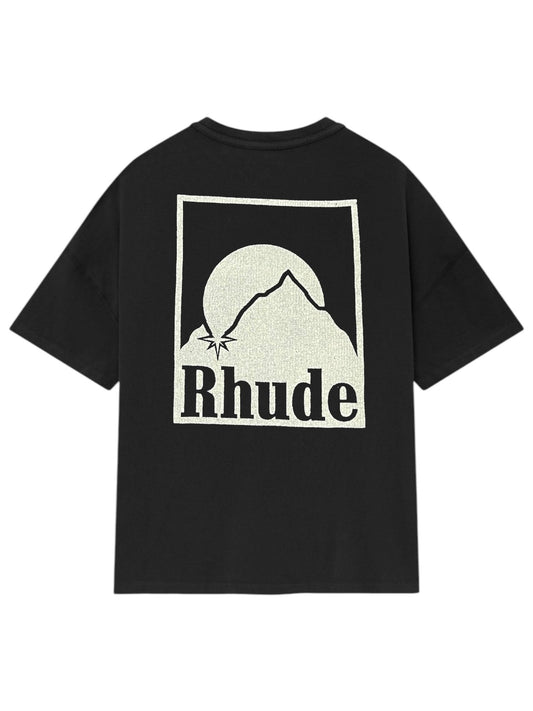 The Rhude Moonlight Badge Tee Black by RHUDE features a mountain silhouette and sun design, seamlessly blending American craftsmanship with luxury. The iconic "Rhude" text adorns the back.