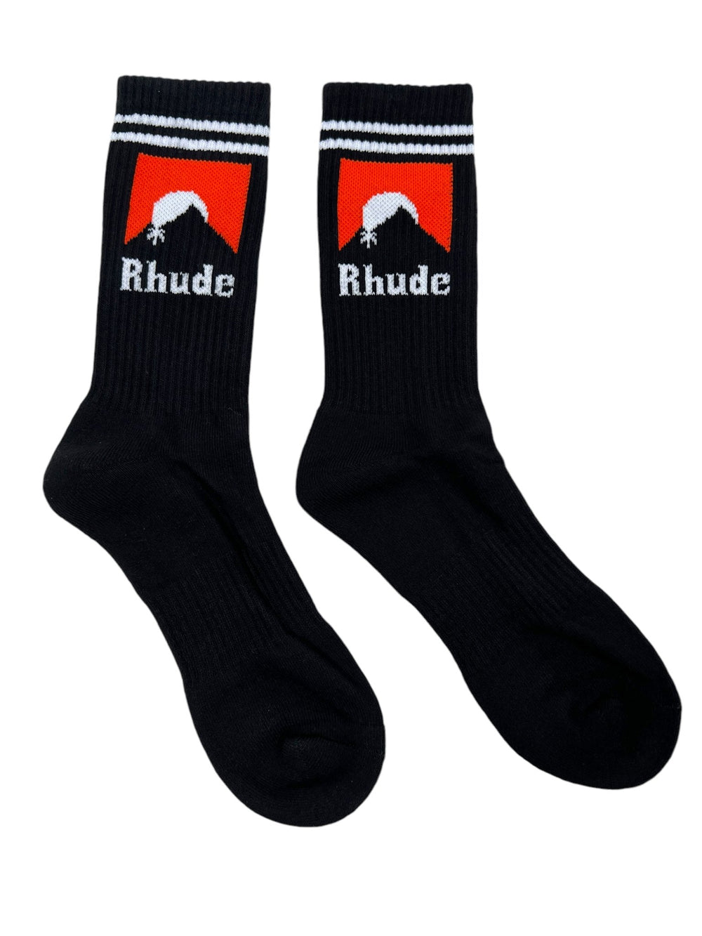 A pair of RHUDE Moonlight socks in black with white stripes at the top and a red and orange logo design featuring the text "Rhude." Made from soft cotton, these RHUDE Moonlight Socks Black/White/Orange offer both comfort and style.