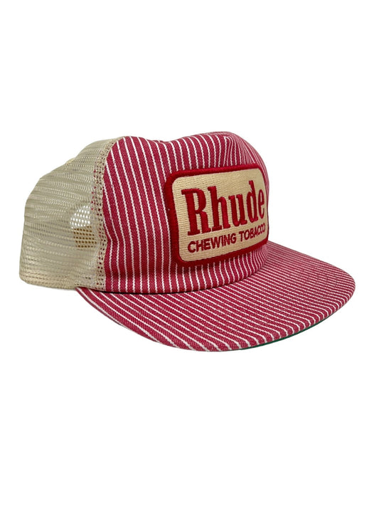 Red and white striped RHUDE RED STRIPED TOBACCO TRUCKER HAT with a beige mesh back. The front features a rectangular patch with the text "Rhude Chewing Tobacco," and an embroidered Rhude logo. Includes an adjustable back strap for a comfortable fit.