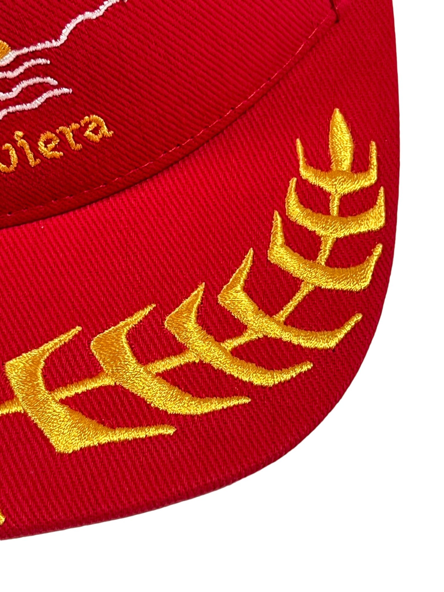 Close-up of a red RHUDE RIVIERA SAILING HAT RED heavyweight cotton hat with gold embroidery, featuring a laurel wreath and Rhude logo design.