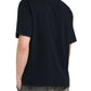 A person wearing a Rhude Saint-Rhude Tee Black by RHUDE and faded jeans is standing with their back to the camera.
