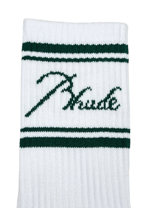 Close-up of a cotton sock with two green stripes and cursive text "Thicke" embroidered between the stripes. These stylish RHUDE SCRIPT LOGO SOCK WHITE socks by RHUDE add a touch of elegance to your wardrobe.