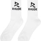 The Rhude Trophy Racing Socks in White/Black are calf-high and made from a knit stretch cotton-blend, featuring a "RHUDE" text and jacquard logo in sleek black.