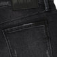 Close-up of the back pocket and waistband of RTA Clayton | Graphite Fade Black skinny jeans, crafted from high-quality denim with a black leather patch embossed with "RTA".