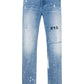 RTA Clayton Jean Distressed White Paint Blue: Light blue skinny jeans with white paint splatter, faded wash, and "RtA" logo on the left thigh for a modern, distressed look.