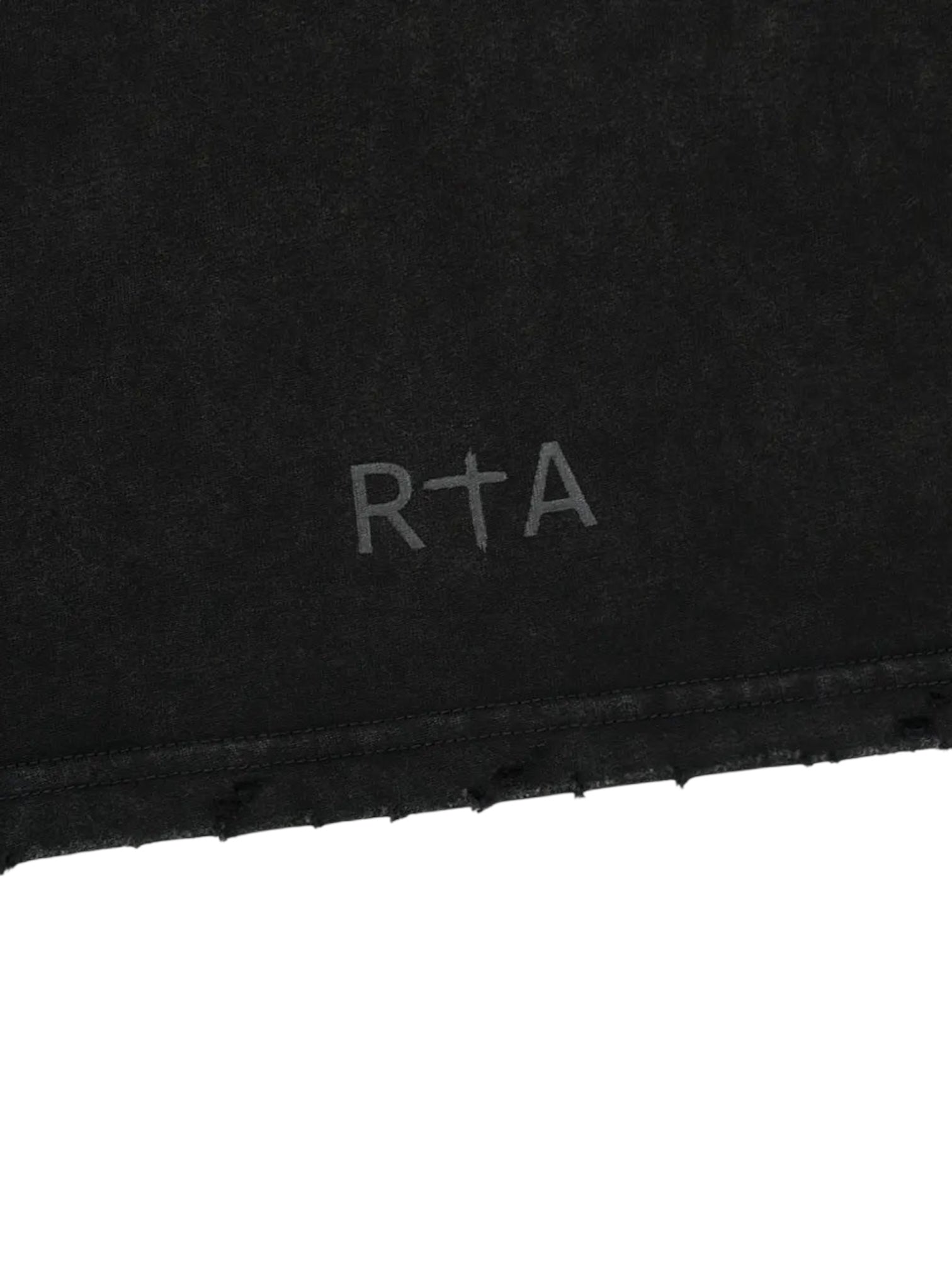 The RTA Colin Black Cyber Sigilism tee features an oversized fit with a light gray RTA logo, incorporating a cross symbol into the letter T near the hem for a cyber-inspired look.