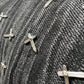 Close-up of RTA Olivier Stacked Graphite Fade Cross Black denim by RTA, showing black and white cotton fabric with multiple small metal cross-shaped studs.
