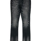A pair of RTA Olivier Stacked Graphite Fade Cross Black jeans in soft cotton, featuring a stylish graphite fade and silver stud embellishments arranged in rows on the upper front thighs.
