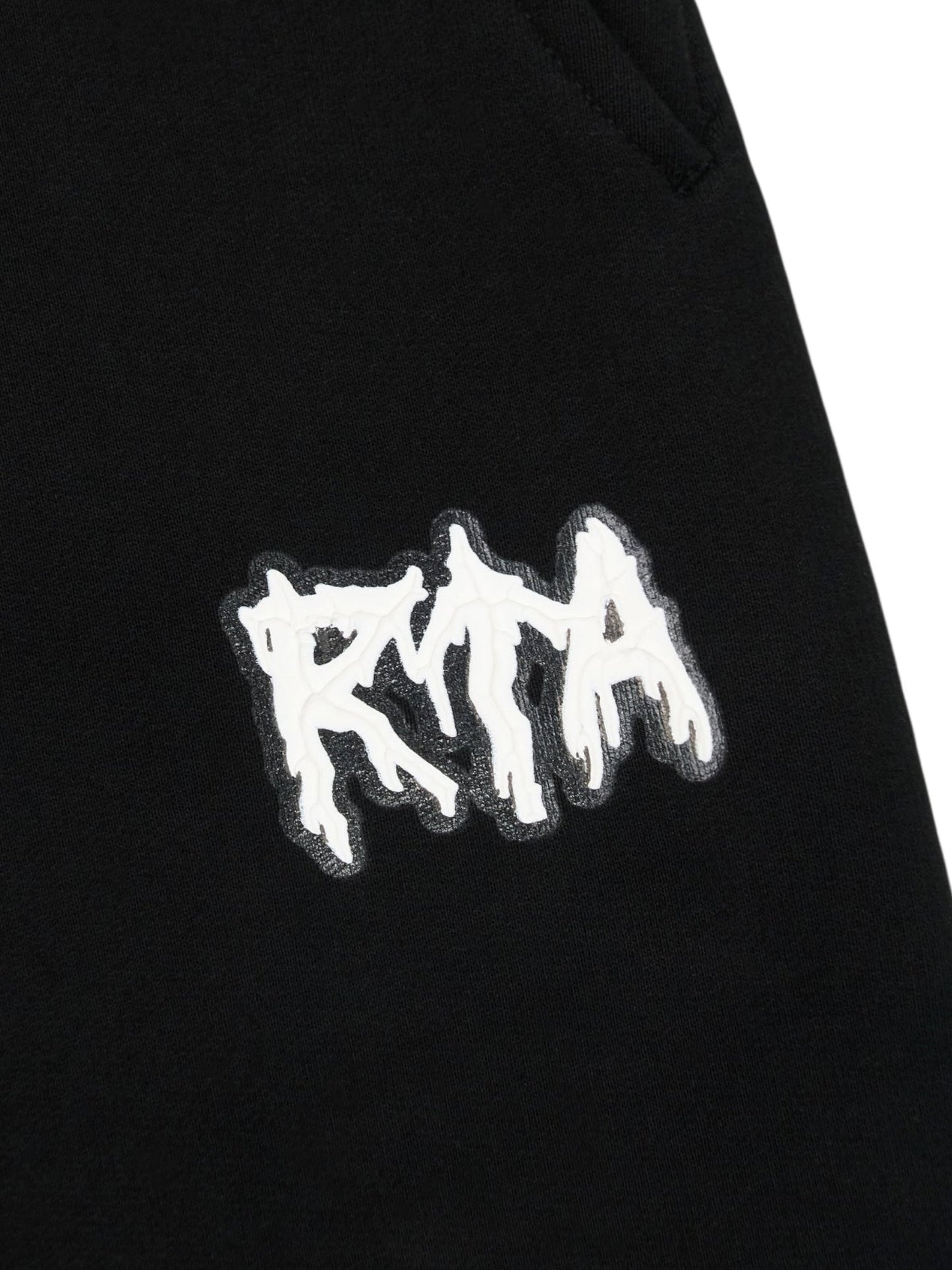 Close-up of the RTA Rafa Black Cyber Lost Frequencies sweatpant by RTA, showcasing a white stylized “RTA” patch stitched on for a cyber-inspired accent.