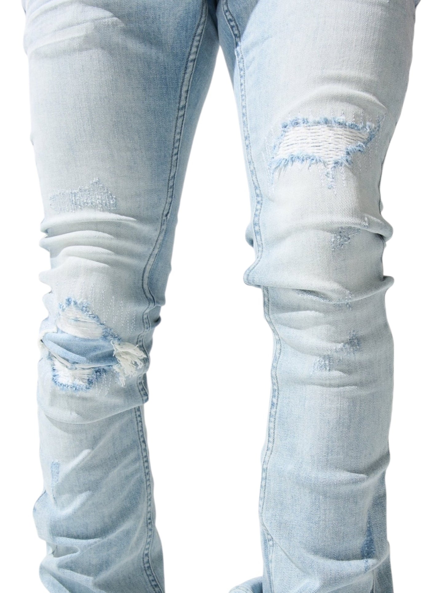 Close-up of Serenede Azul Stacked Jeans Sky by SERENEDE in light blue, featuring distressed details with visible rips and fraying at the knees and thighs, highlighting their unique cotton spandex blend.