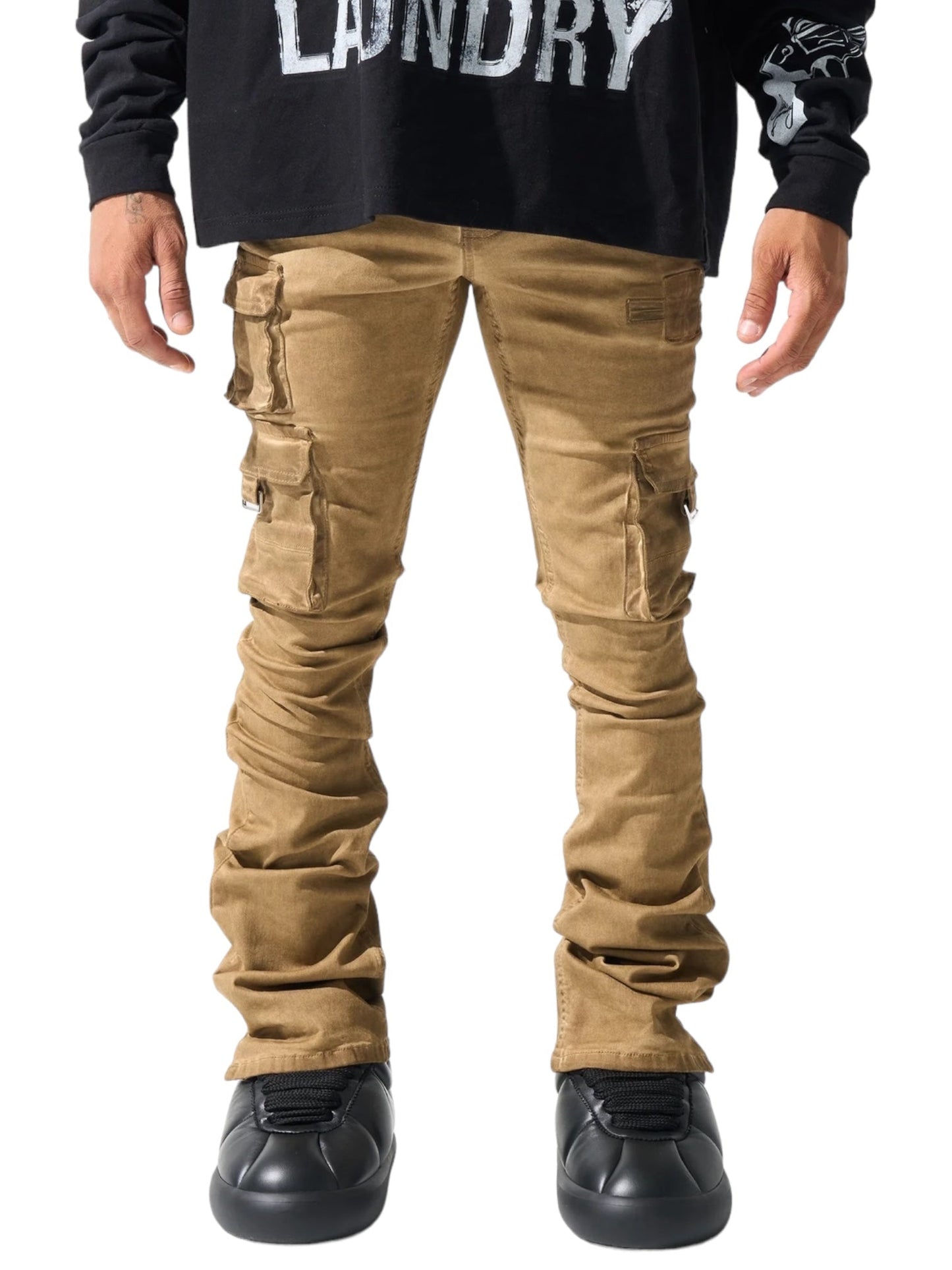 A person wearing the SERENEDE CINNAMON CARGO STACKED BRWN long-sleeve shirt in black and khaki cargo pants with multiple pockets, featuring a leather logo patch by SERENEDE.