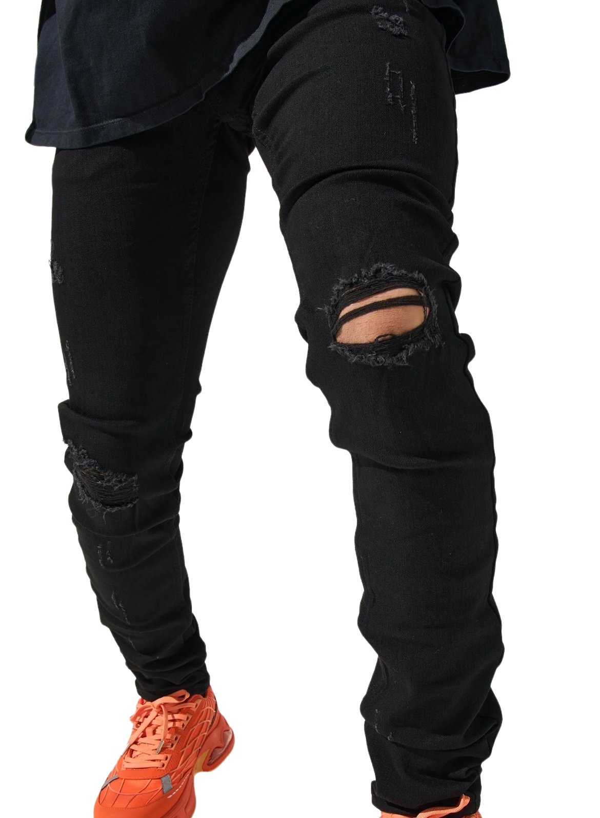 A person wearing SERENEDE MIDNIGHT BLACK distressed jeans with a visible knee hole and orange sneakers.