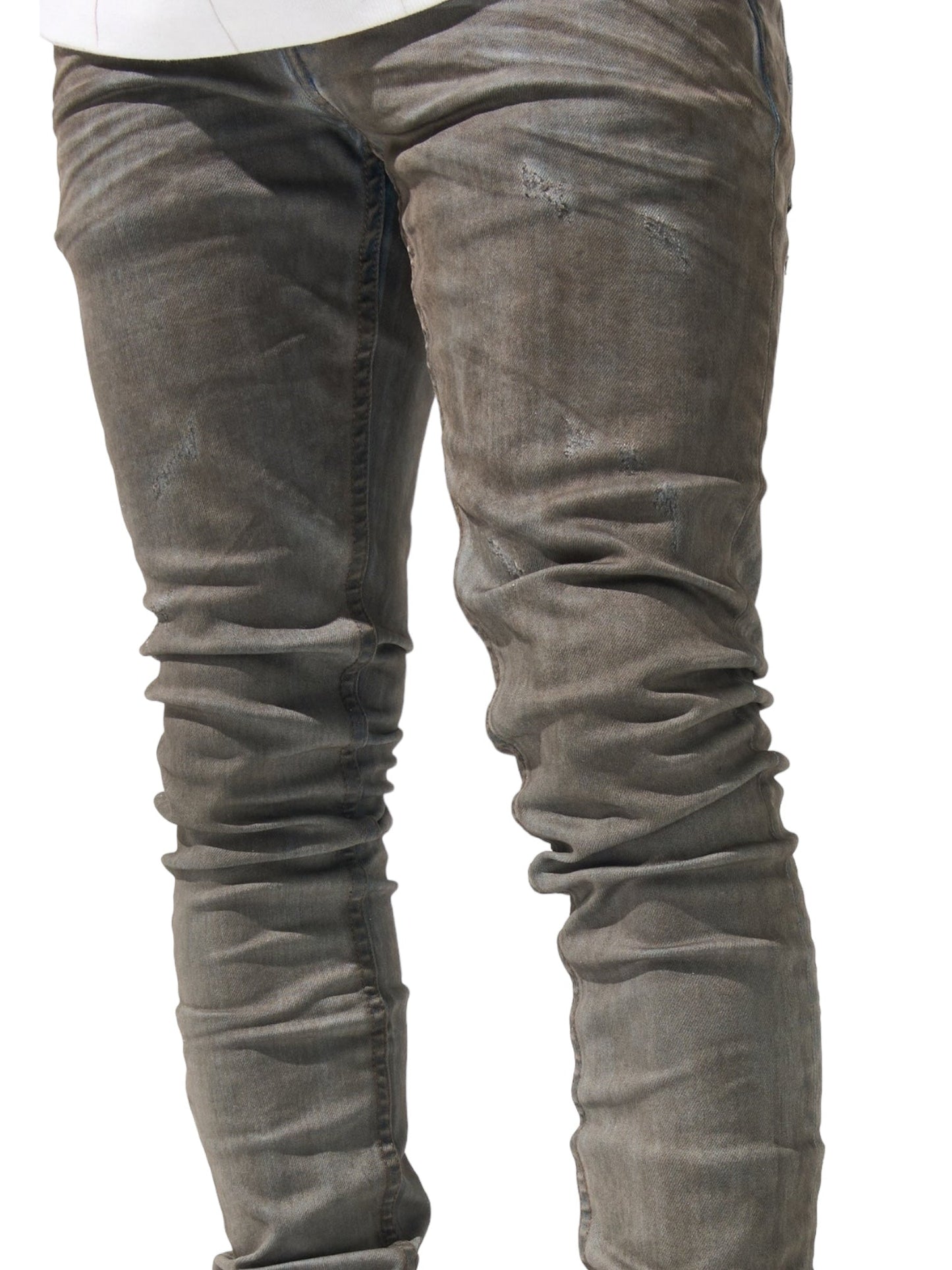 Close-up of a person wearing fitted, distressed "SERENEDE NIGHTFALL JEANS NIGHTBLUE" by SERENEDE with visible creases and subtle wear patterns, in a dark grey and blue wash.