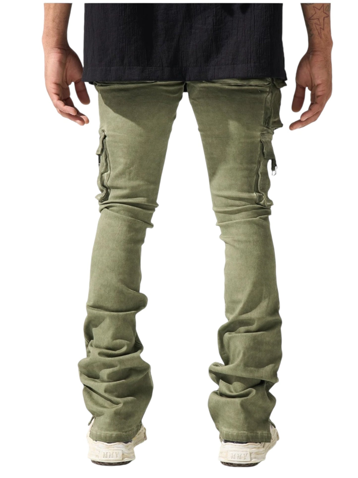 A person wearing olive Serenede Oil Cargo Stacked Jeans from SERENEDE and white shoes stands with their back to the camera against a white background.