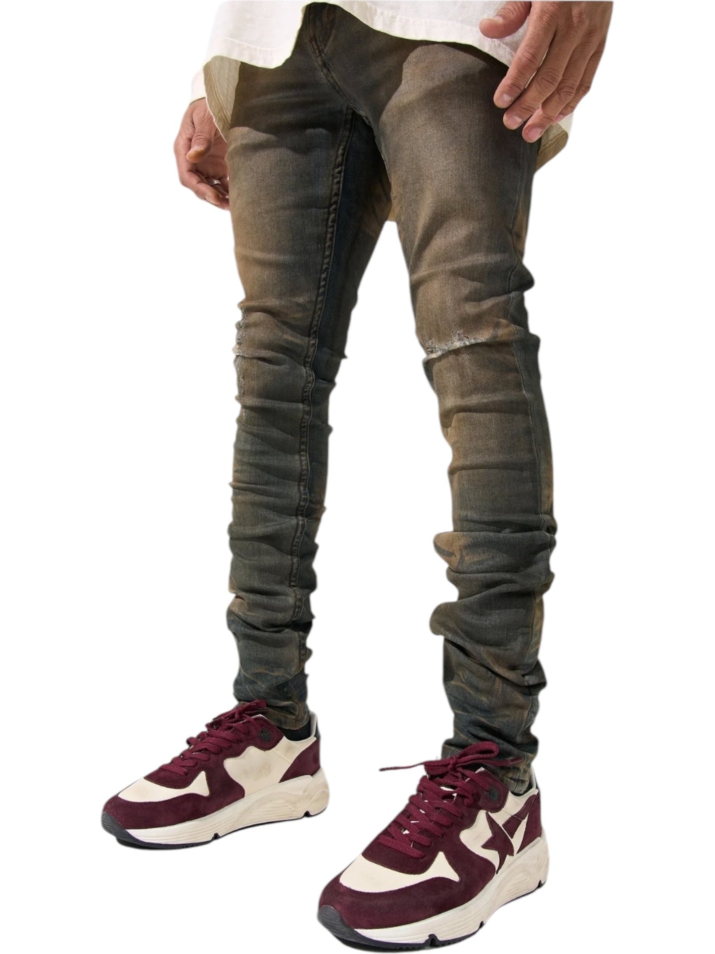 Against a plain white background, the person wears SERENEDE's Serenede Oud Jeans Oudwood skinny fit denim with a crisp white shirt and maroon sneakers with white accents.