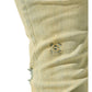 A detailed close-up of the SERENEDE SOL JEANS RISE from SERENEDE reveals the faded yellow denim fabric, highlighting an intricate embroidered design and a distressed area near the seam. Made with stretch cotton for ultimate comfort, these slim-fit men's jeans seamlessly combine style and wearability.