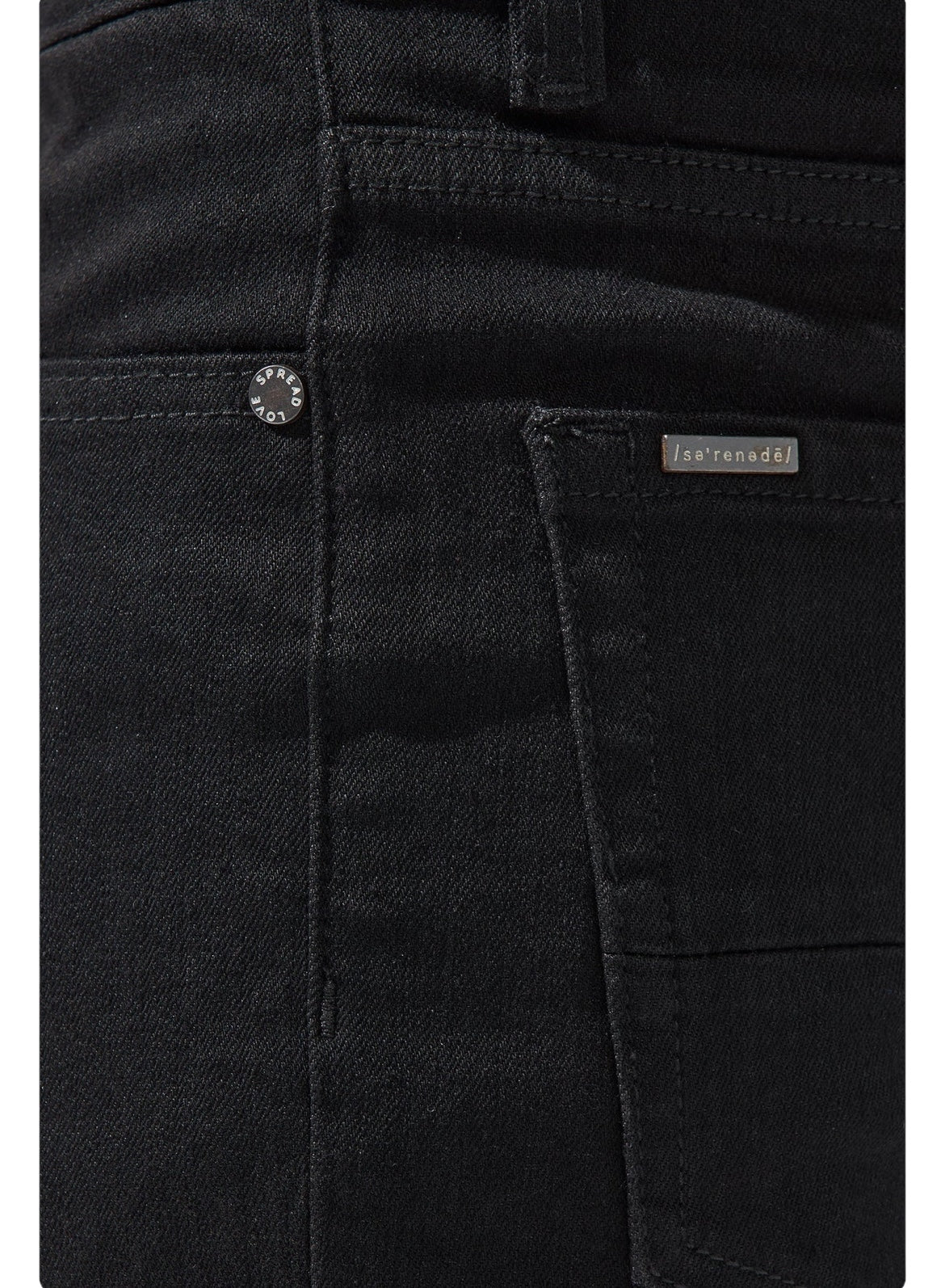 Close-up of the back pocket on a pair of SERENEDE VANTA 11 JEANS BLACK with visible metal button and a small label with text, showcasing the premium fabric and SERENEDE skinny fit.