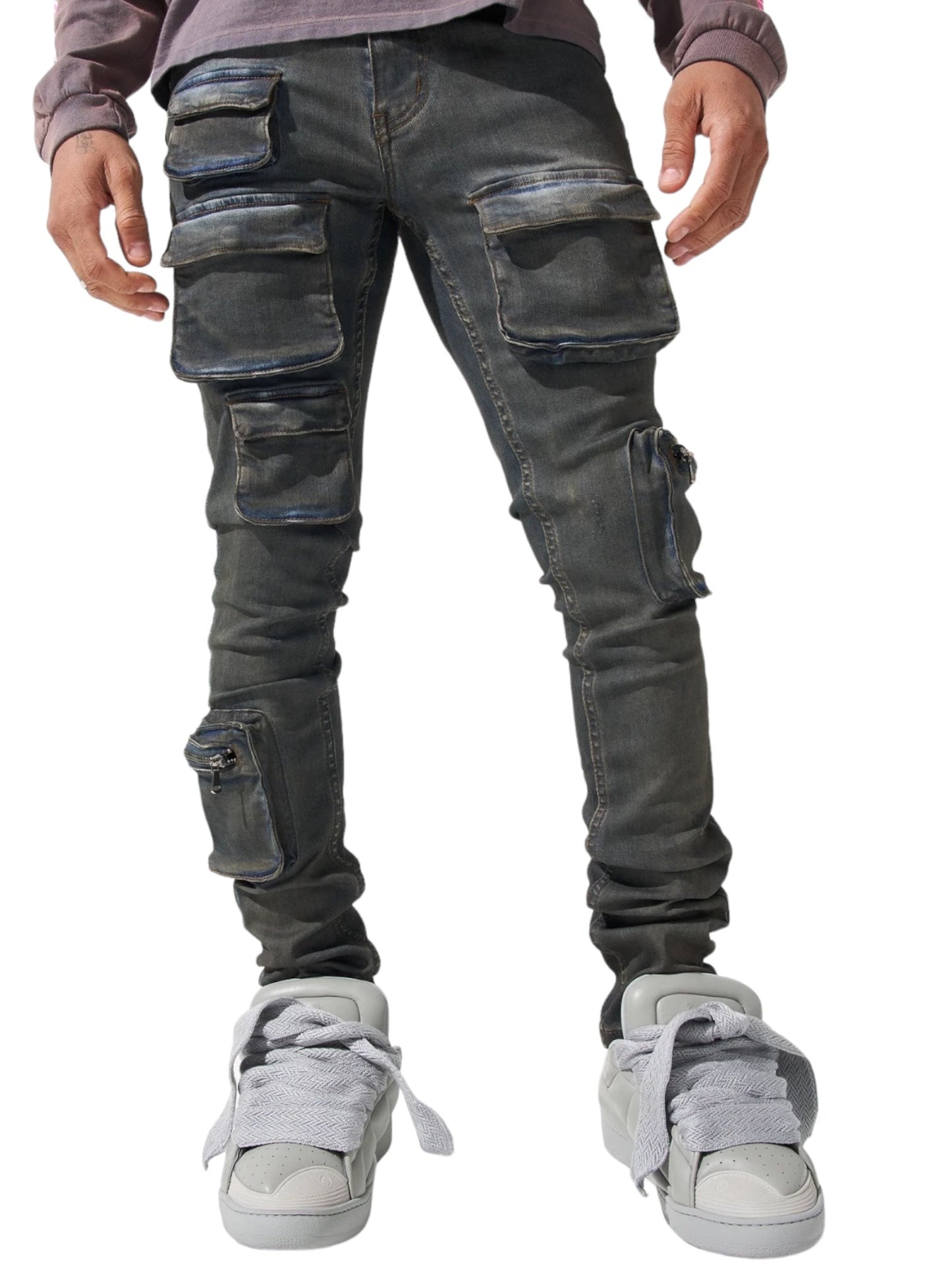 Man wearing SERENEDE WAVE CARGO JEANS in Atlantic dark blue with multiple zippers and pockets, paired with white high-top sneakers.