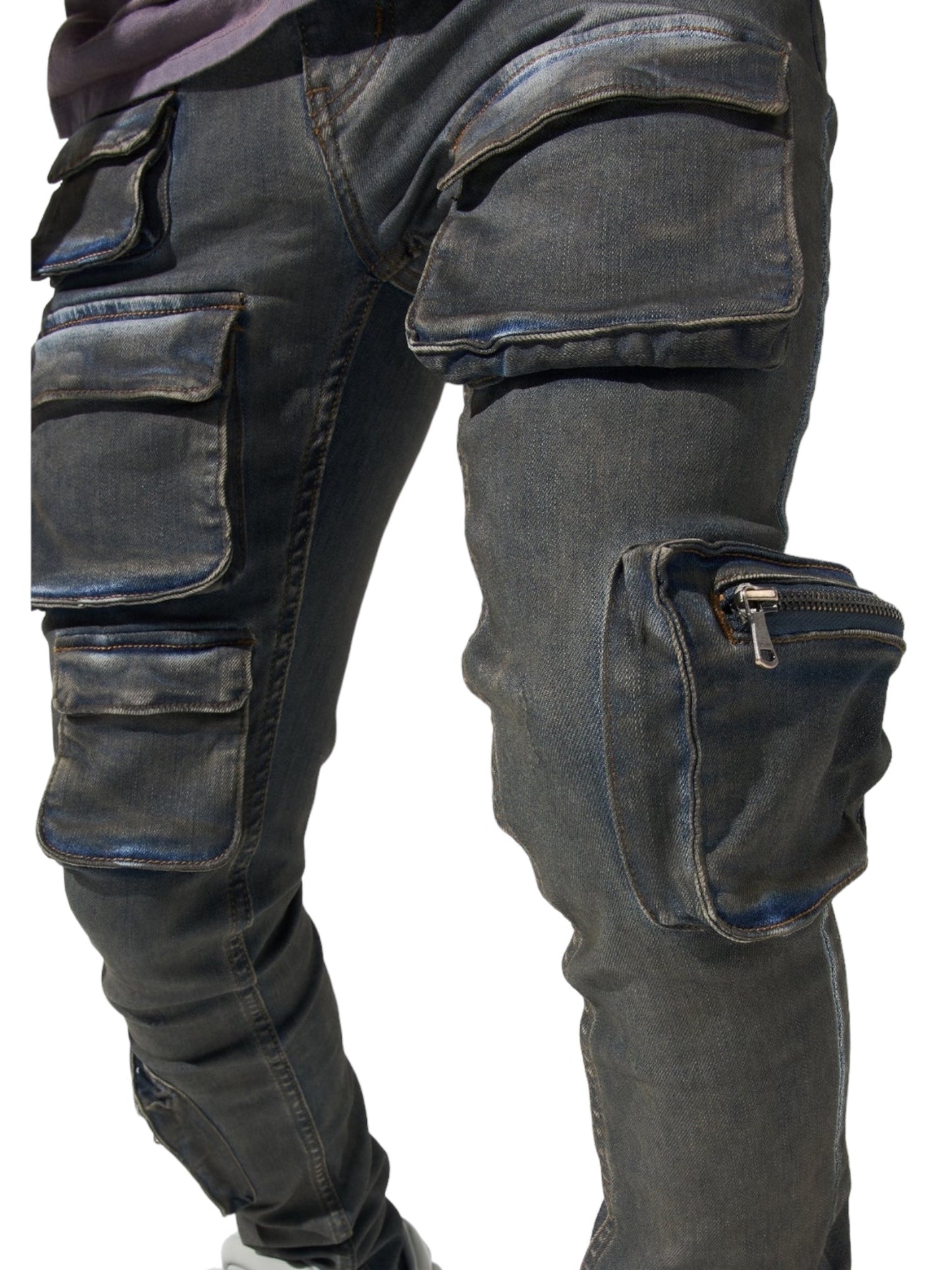 Close-up of a person wearing SERENEDE WAVE CARGO JEANS by SERENEDE in a faded atlantic dark blue hue. The jeans feature multiple pockets and zippers, boasting a worn-in look with visible stitching that highlights their tactical fabrication details.