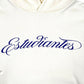 The Students Estudiantes Pullover Hoodie by STUDENTS is a crisp white, 100% cotton hoodie featuring "Estudiantes" in blue cursive across the chest—ideal for students.