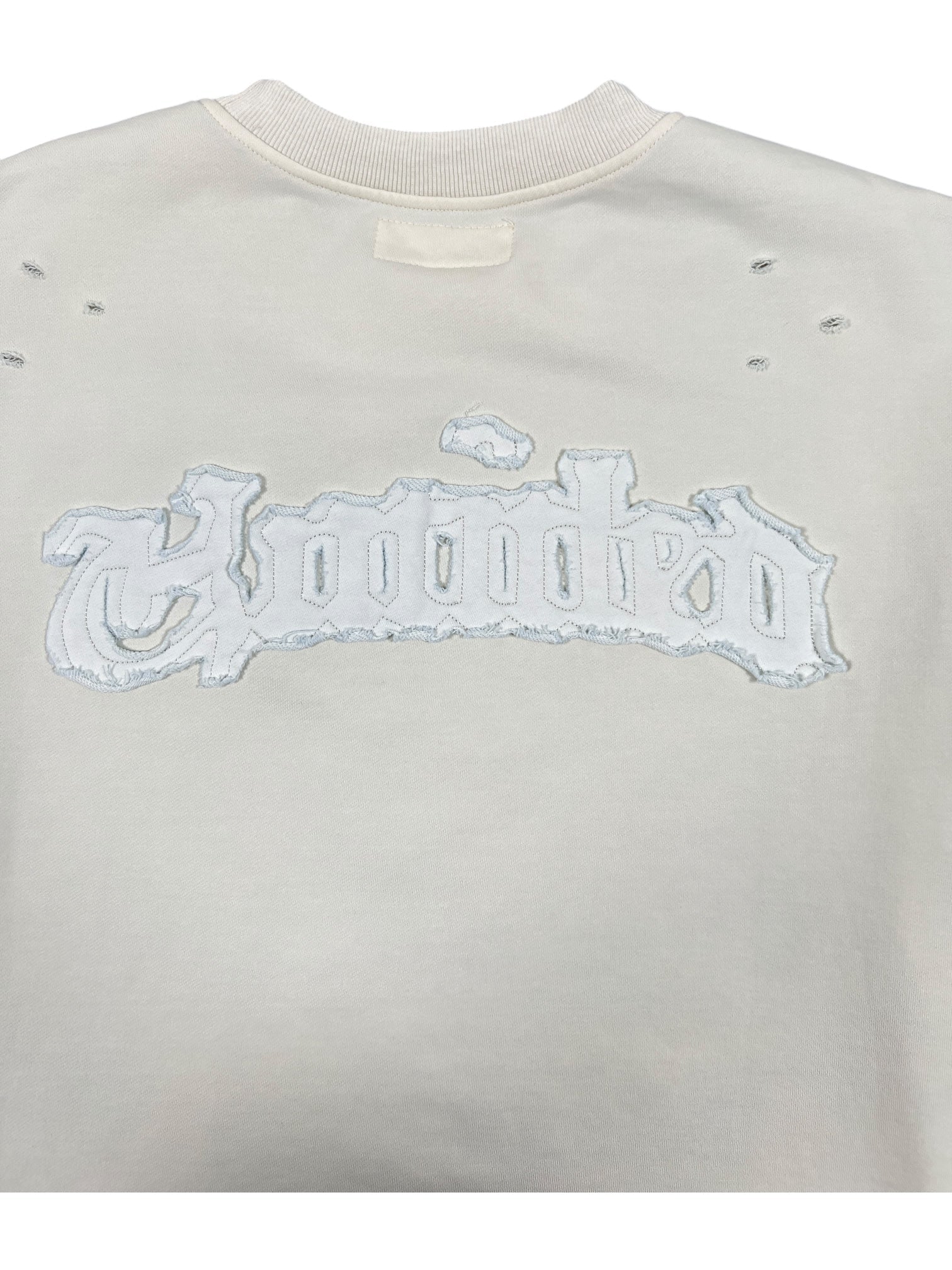 The Untitled Artworks Crewneck Short Sleeve Cream by UNTITLED ARTWORKS is a 100% cotton cream sweatshirt with "Hooded" stitched across the back in a distressed, gothic-style font.
