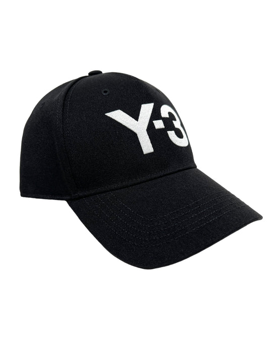 Black baseball cap with a curved brim, featuring the embroidered ADIDAS x Y-3 logo in large white letters on the front. Product Name: Y-3 H62981 Y-3 LOGO CAP BLACK.