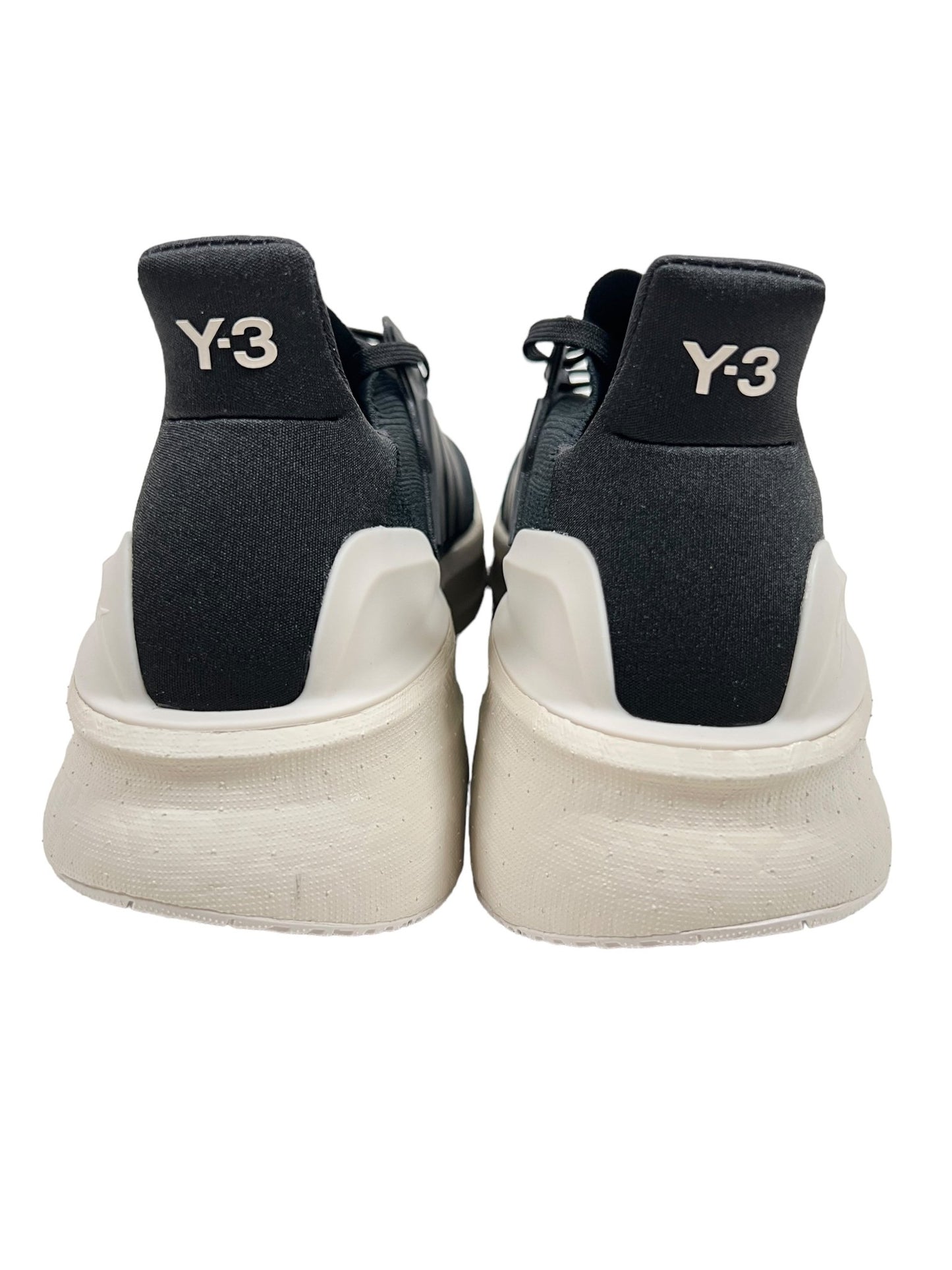 Rear view of Y-3 IH0871 Ultraboost 5 Cblack/Alum sneakers by ADIDAS x Y-3, featuring a sleek black design with white soles, created with adidas PRIMEKNIT and designed by Yohji Yamamoto.