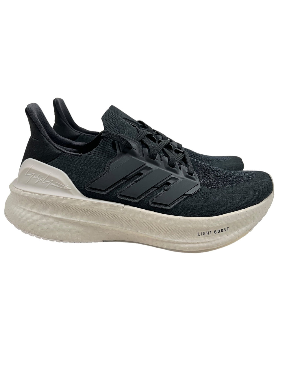 Discover the sleek design of the Y-3 IH0871 Ultraboost 5 Cblack/Alum athletic shoes by ADIDAS x Y-3, featuring a thick white sole with "Light Boost" on the side. Crafted with adidas PRIMEKNIT, these shoes embody the innovative spirit of the Y-3 Ultraboost, seamlessly blending performance and style.