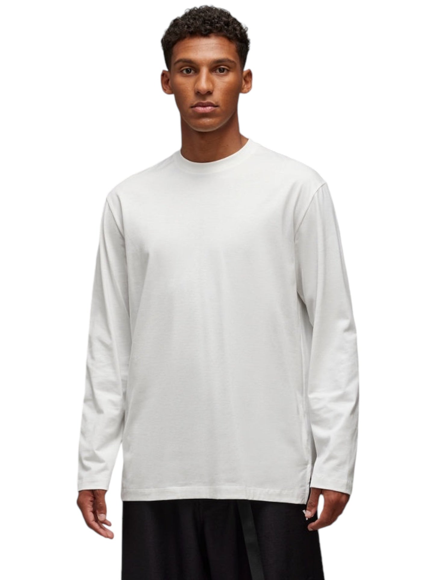 A person wearing the ADIDAS x Y-3 JM3234 U GFX LS Tee in Cwhite and black pants stands against a white background.