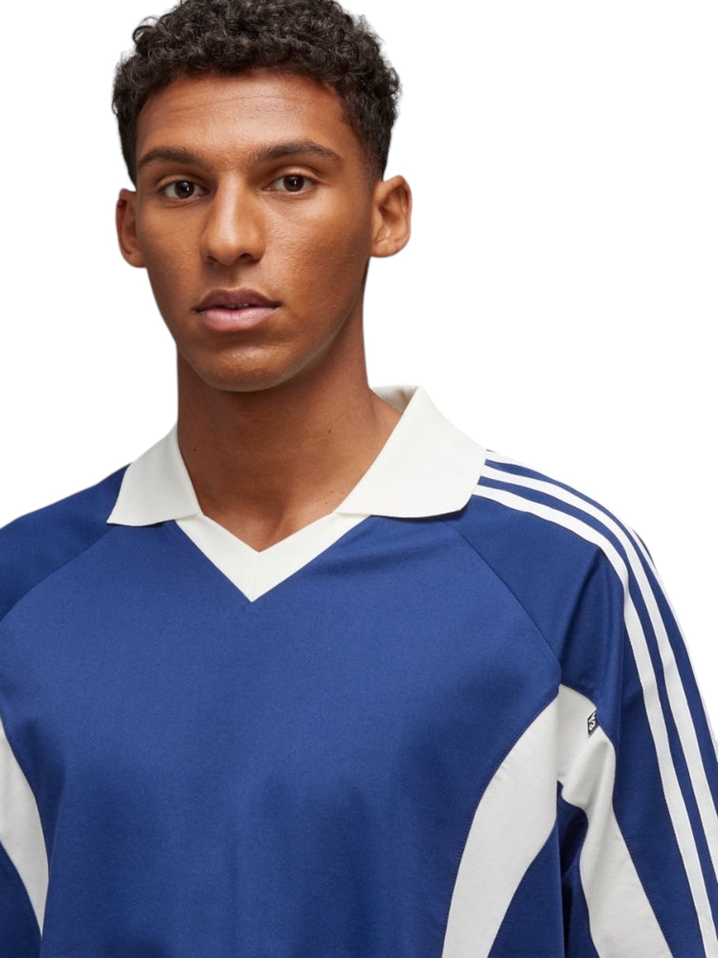 A person wearing a dark blue sports jersey, reminiscent of the iconic Y-3 JM8338 SS CTLN Tee Dkblue with its three stripes on the sleeves, stands against a plain background. The ADIDAS x Y-3 logo subtly adorns the blend of cotton and polyester fabric.